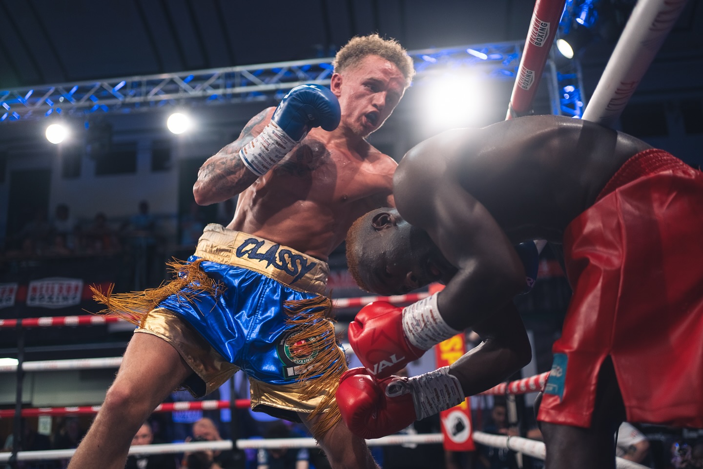 Boxer landing a punch, dramatic ring lighting